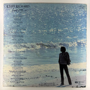 Album cover with silhouette of a person on a beach and text