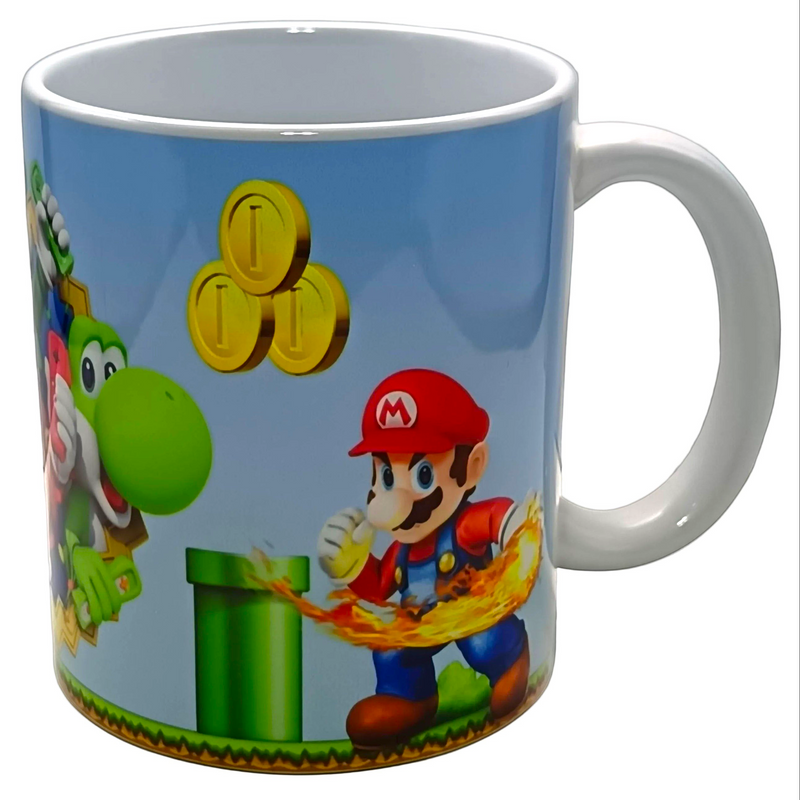 A white ceramic coffee mug featuring a colorful print of Super Mario characters, including Mario throwing fire, a green pipe, coins, and Yoshi, set against a light blue background.