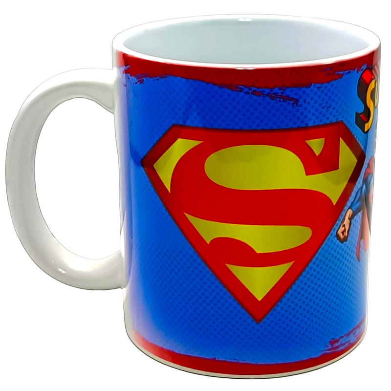 A white ceramic coffee mug featuring a blue, red, and yellow Superman comic book style graphic on the side.